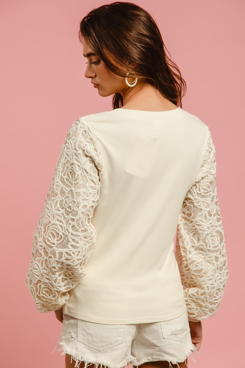 BiBi Solid Color Ribbed Top with Chenille and Sequin Floral Sleeves in Cream