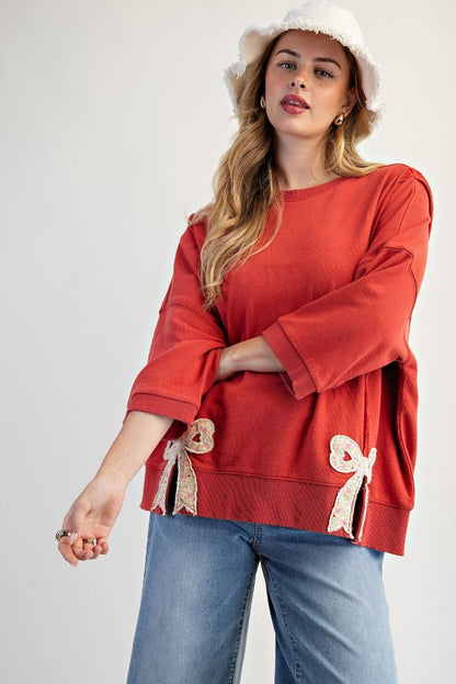 Easel Solid Color Terry Knit Top with Applique Bows on Hem in Boho Red