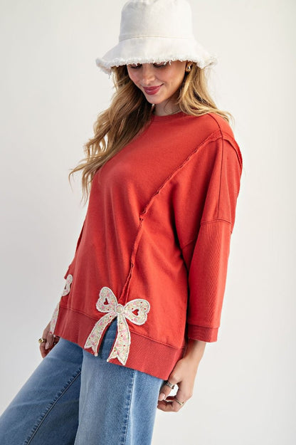 Easel Solid Color Terry Knit Top with Applique Bows on Hem in Boho Red
