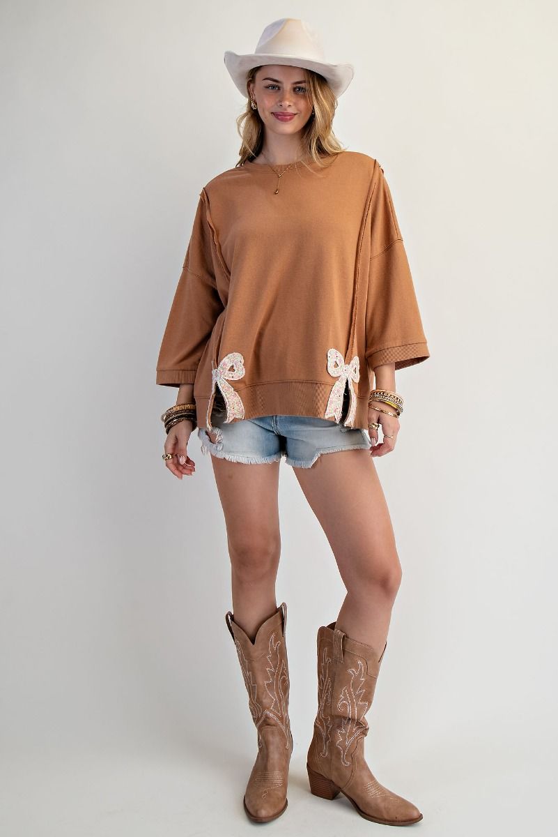 Easel Solid Color Terry Knit Top with Applique Bows on Hem in Camel