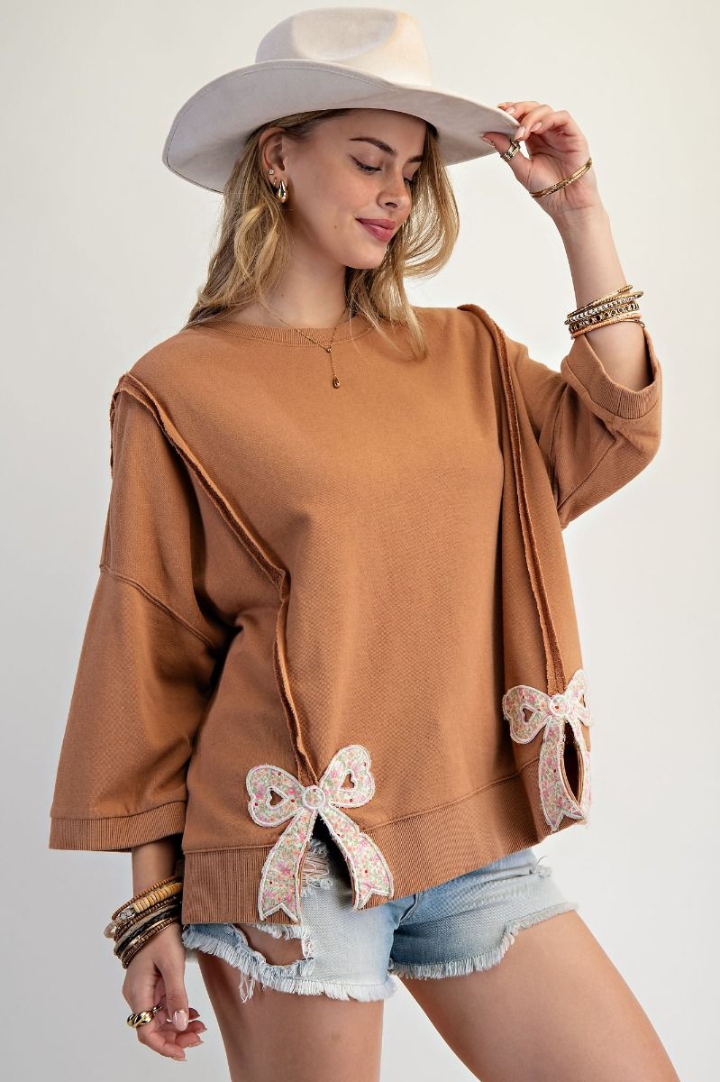 Easel Solid Color Terry Knit Top with Applique Bows on Hem in Camel
